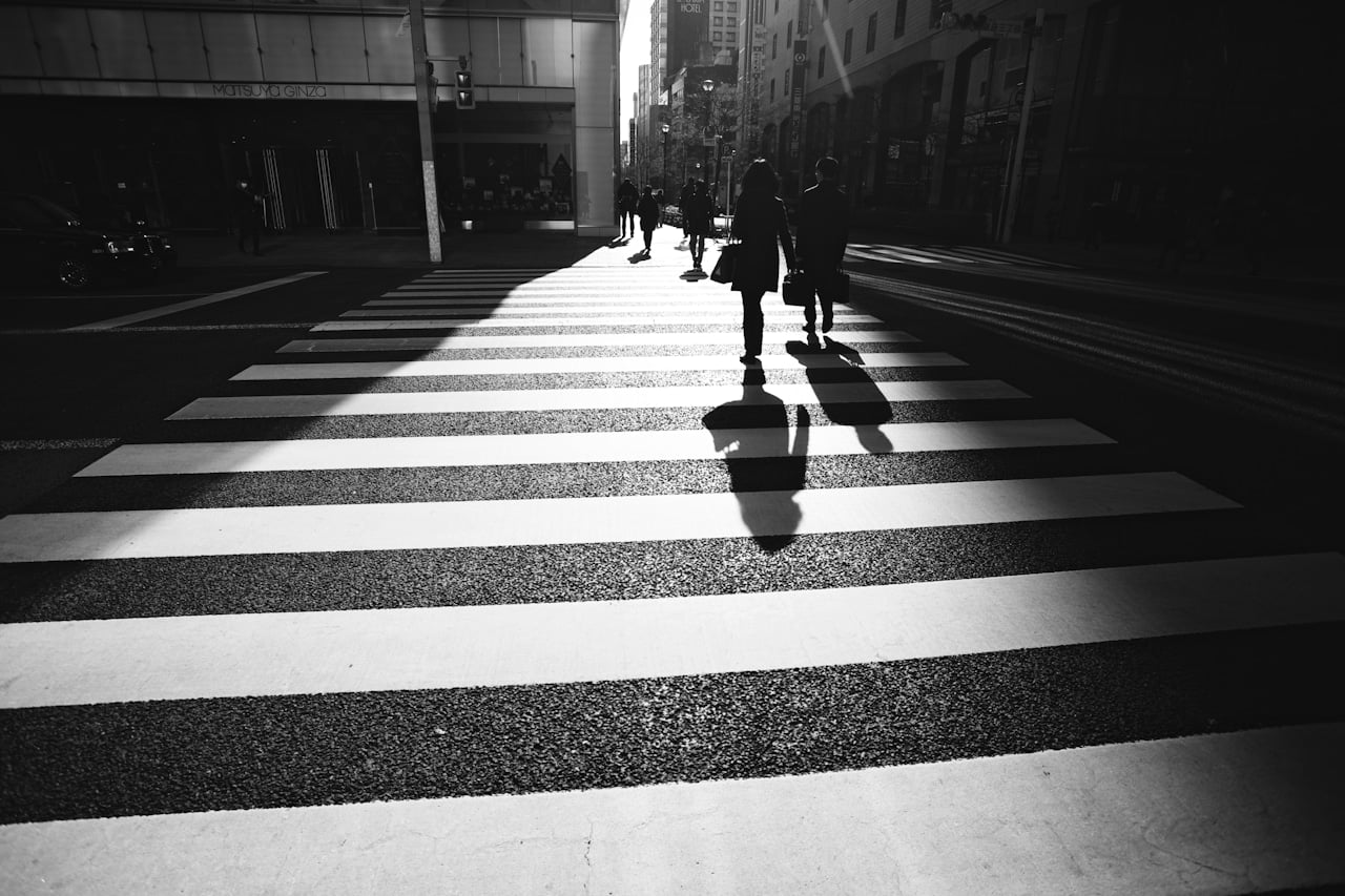 black and white photo of people crossing the street in brooklyn