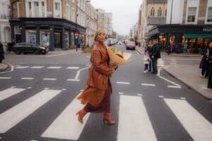 woman crossing the street in brooklyn with a bouquet of flowers