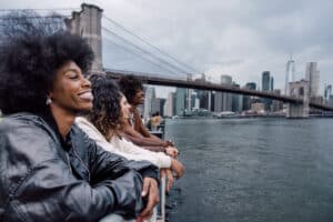 A multi-ethnic group of friends meeting up in the city street to have fun in New York.